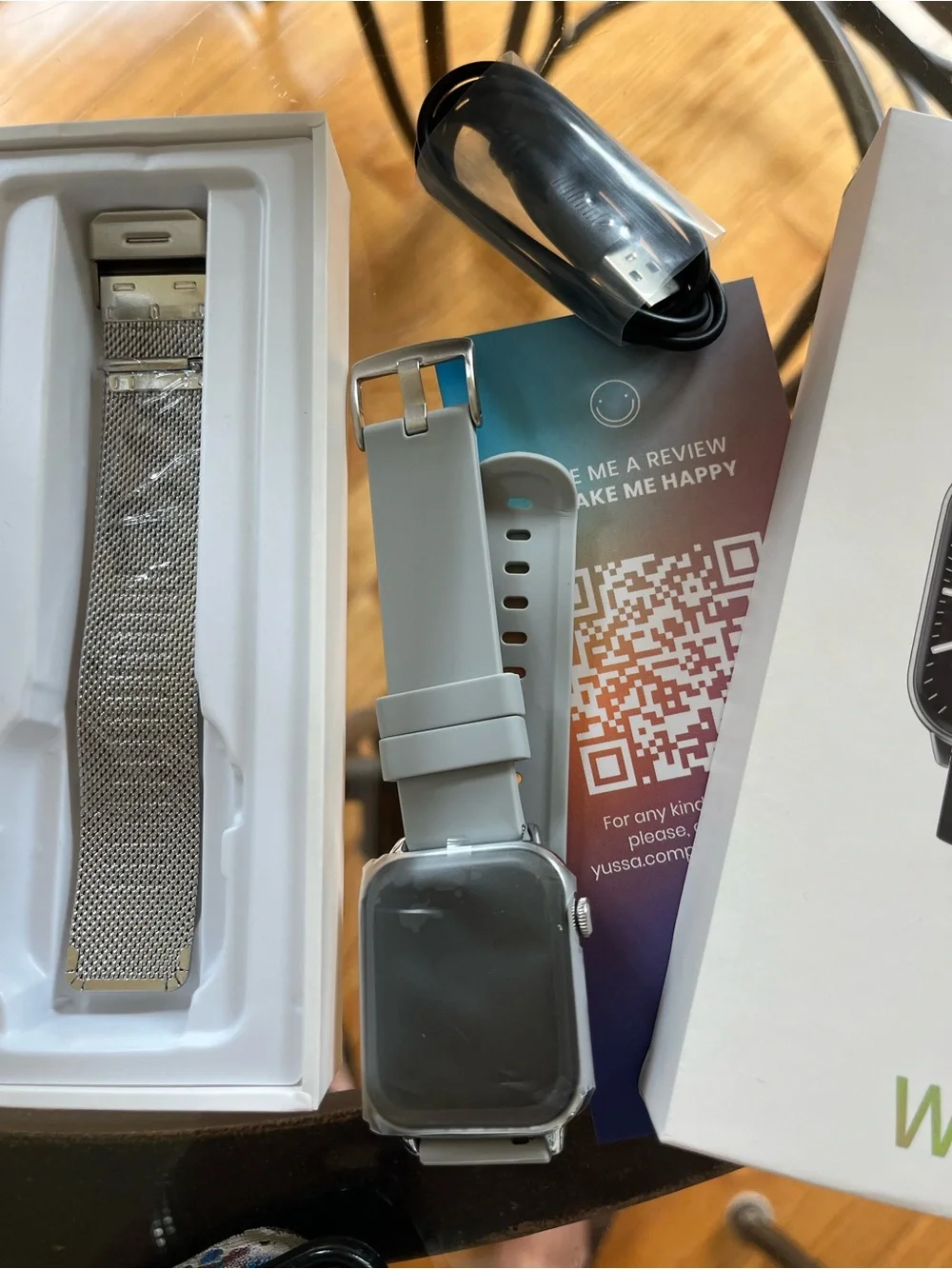 New Yussa smartwatch with a silver-tone case and a grey silicone strap.